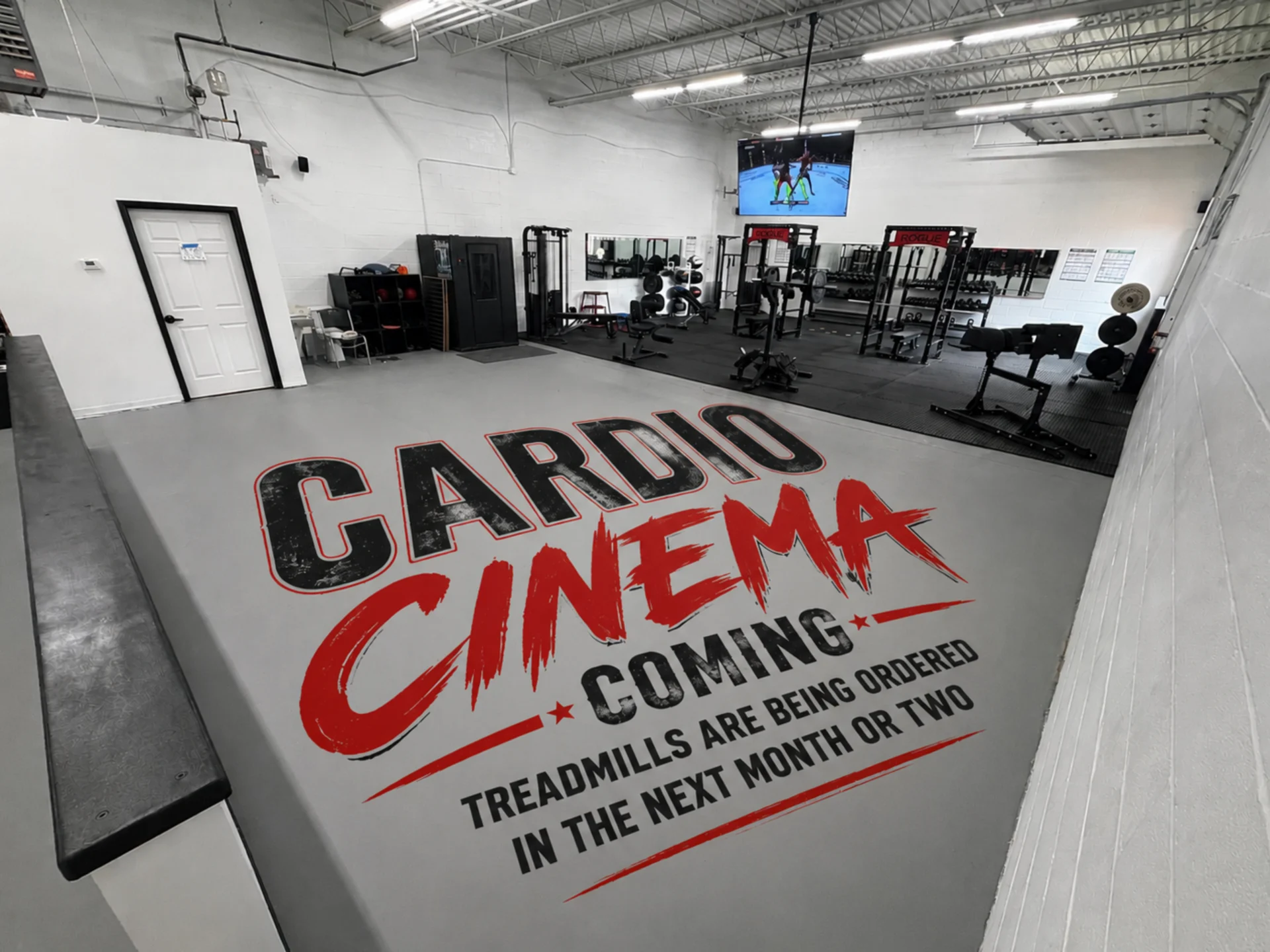Gym with "Cardio Cinema" announcement on floor.