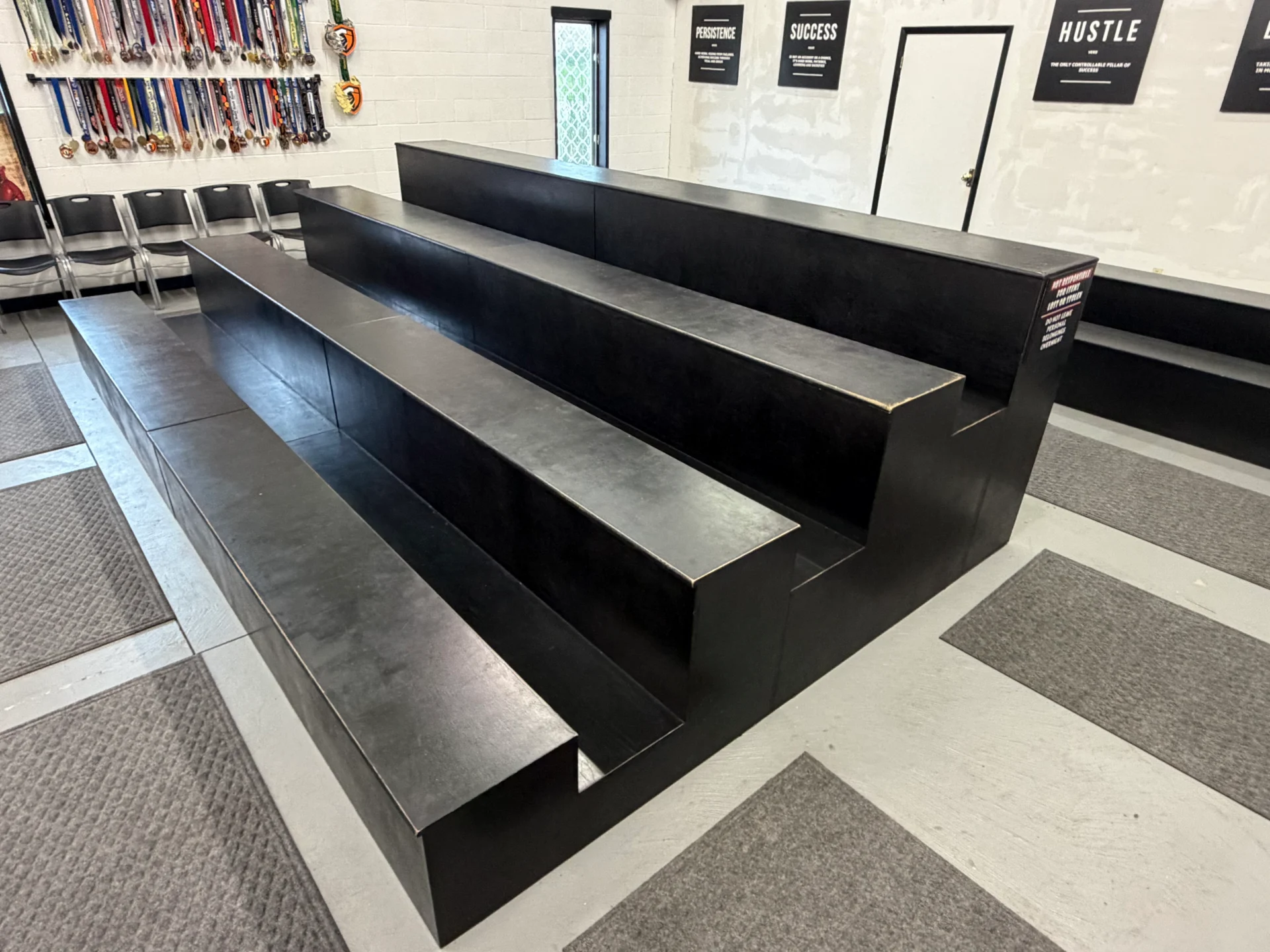 Black tiered seating in a gym.
