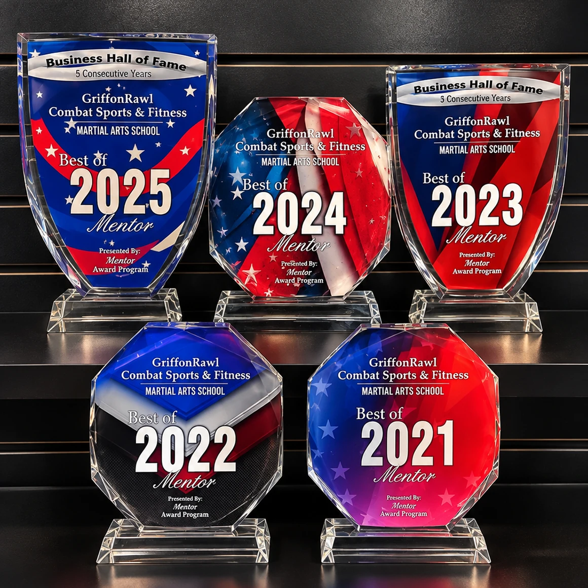 Set of four glass awards on a black background